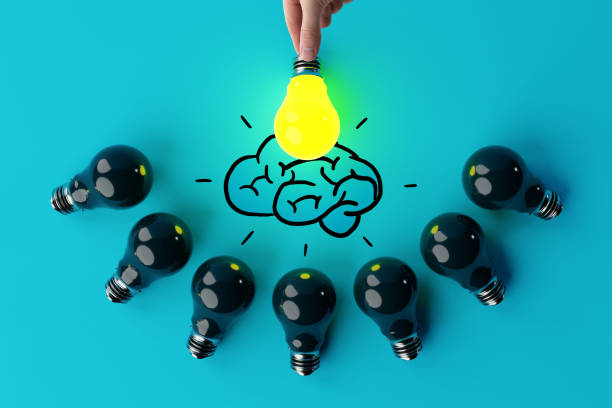 istock A hand holds a lit light bulb against the background of other extinguished light bulbs and a sketch of the brain. 1441263521