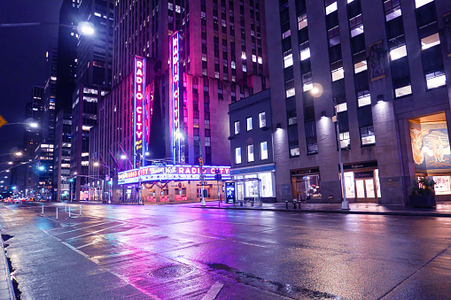 Radio City Music Hall at rainy night with reflection. New York City, November 12, 2022