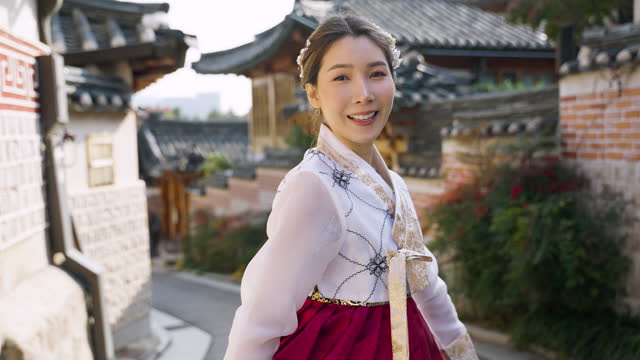 Asian woman wearing Korean hanbok traditional dress traveling in Bukchon Hanok village in Seoul