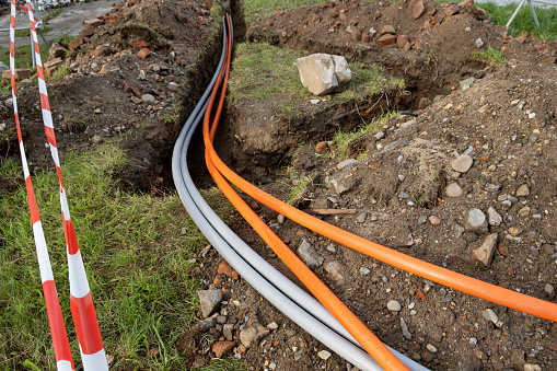 underground cable connecting infrastructure installation. Construction site with communication Cables protected in tubes. high speed Internet Network cables are buried on the street