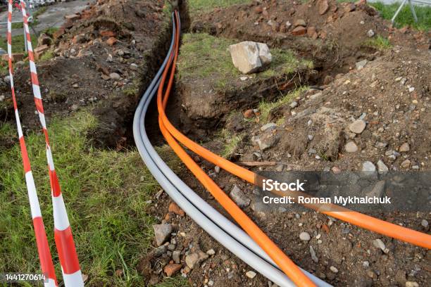 Underground Cable Connecting Infrastructure Installation Construction Site With Communication Cables Protected In Tubes High Speed Internet Network Cables Are Buried On The Street Stock Photo - Download Image Now