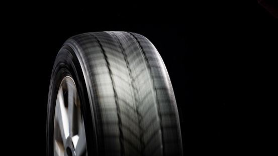 Modern car wheel on light alloy disc, front view isolated on white background