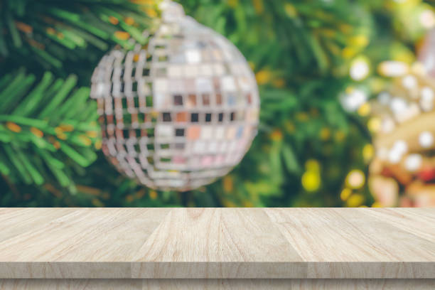 istock Empty wood table top with blur Christmas tree with bokeh light background 1441275569