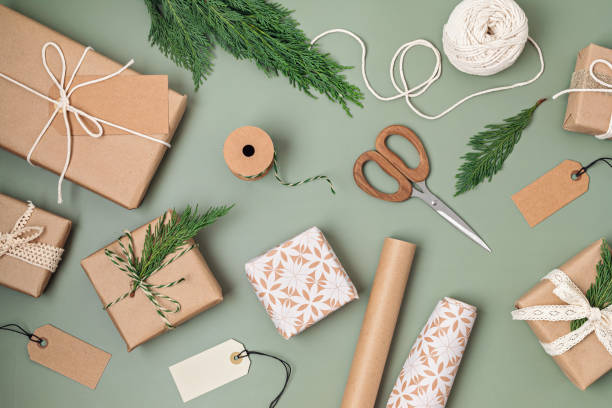 istock Christmas background with gift boxes and rolls of kraft wrapping paper 1441276694