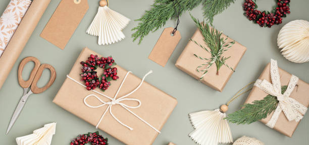 istock Christmas background with gift boxes and rolls of kraft wrapping paper 1441276697