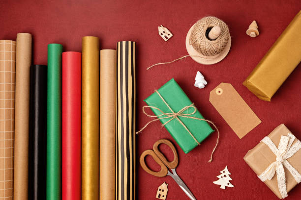 istock Christmas background with gift boxes and rolls of kraft wrapping paper 1441276702