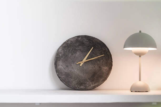 istock Clock and light stand on the shelf 1441280707