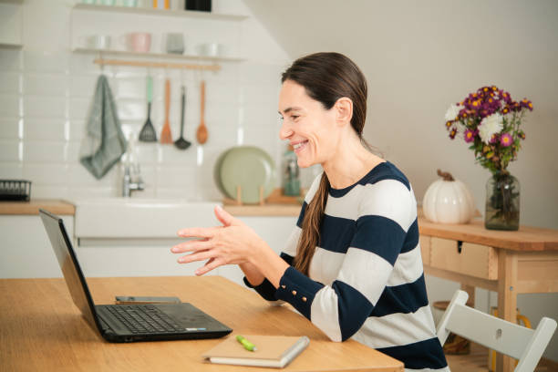 istock Happy woman working online from home 1441284452