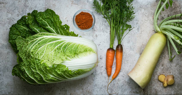 Kimchi ingredient Kimchi ingredients: napa cabbage, daikon radish, ginger, carrots and hot pepper. cruciferous vegetables stock pictures, royalty-free photos & images