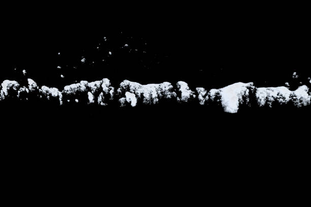istock white snow isolated on a black background. Winter elements for design 1441290050