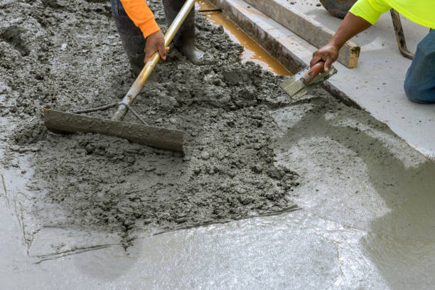 istock Construction workers pour cement to create an additional new sidewalk on the side of the house 1441297368