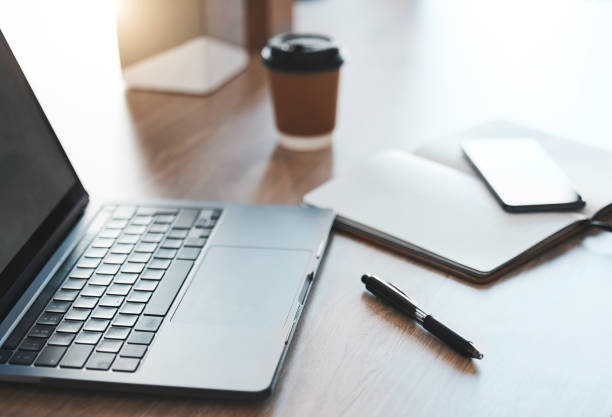 istock Empty desk, laptop and coffee shop with notebook, pc tech and pen for SEO, UX and UI web design at cafe store workspace. Desk or table with digital computer on internet wifi for online business email 1441301529