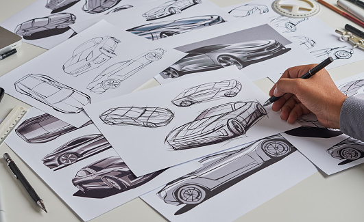 Designer engineer automotive designÂ drawing sketch development Prototype concept car industrial creative.