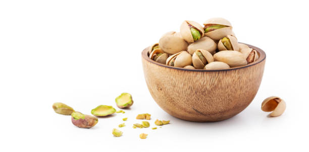 istock Pistachio in wood bowl on white background 1441307839