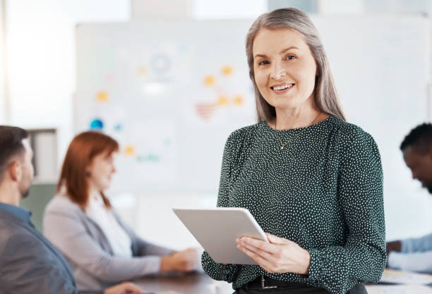 istock Ceo, leadership or manager on digital tablet while standing in a presentation in the office. Portrait of a corporate boss in business meeting with her team or employees in the company conference room 1441310162