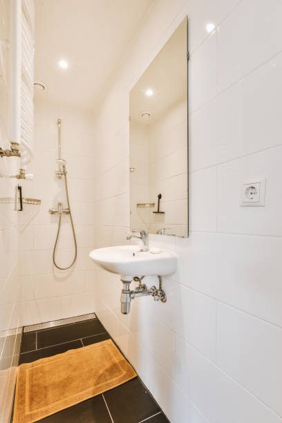istock Bathroom interior in light tones with shower and small sink 1441311444