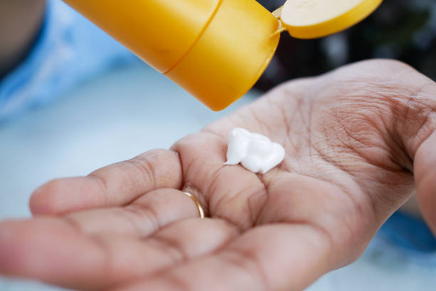 istock person hand using sunscreen cream outdoor 1441314092