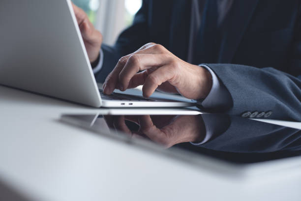 istock Businessman working on laptop computer with digital tablet on white office table 1441314643
