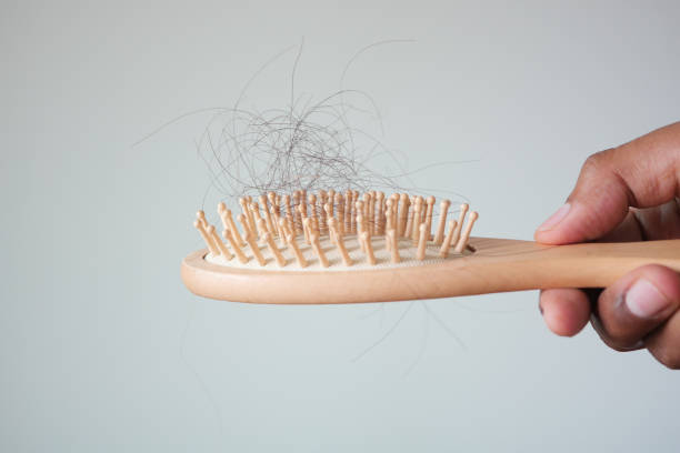 istock man hold his list hair close up 1441315203