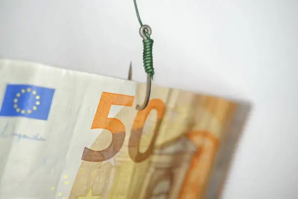Photo of fifty-euro bill hooked on a fishing hook