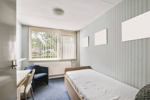 istock The interior of a bedroom with a small bed and a workplace 1441317761