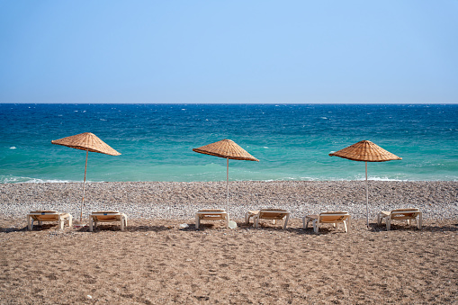 Splendid view at the sea. Post card view. Sunny beach with umbrellas and sunbeds