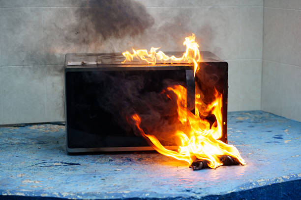 istock microwave oven on fire. the concept of fire in the kitchen. 1441320886