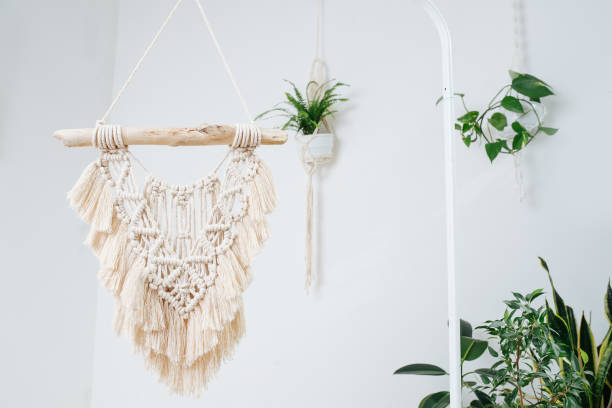 istock Macrame suspended in the air from frame rack. Potted plants around 1441325864