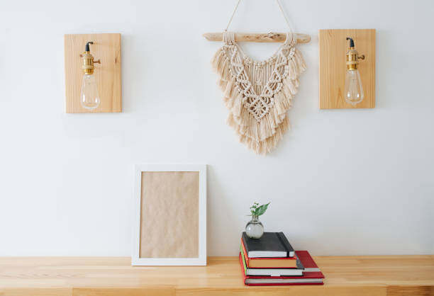 istock Frame mockup on the shelf next to a pile of books under macrame hanger 1441325880