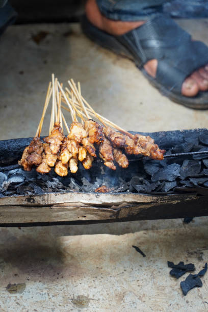 chicken satay on the grill. delicious indonesian cuisine - white meat flash imagens e fotografias de stock