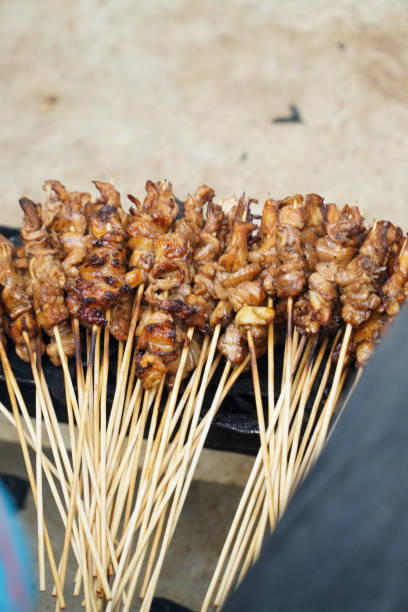 chicken satay on the grill. delicious indonesian cuisine - white meat flash imagens e fotografias de stock