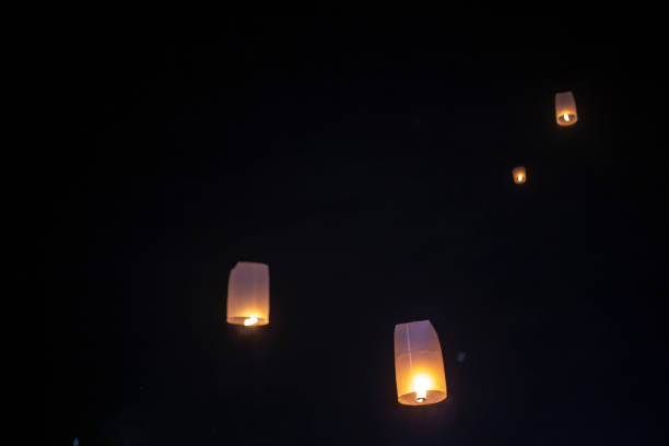 istock The sky lanterns fly up in the dark sky. 1441328781