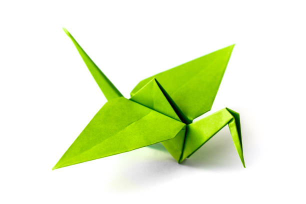 istock Green paper crane origami isolated on a white background 1441330867