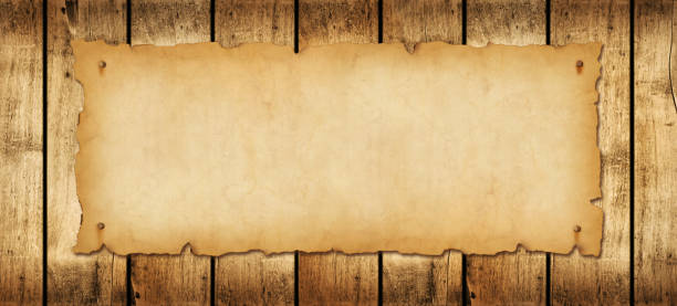 istock Old paper horizontal banner. Parchment scroll on a wood board 1441331159