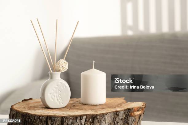 Incense Sticks In Aroma Diffuser And White Scented Candle On Wooden Stand On Table In Living Room Aromatherapy Home Fragrance Concept Of Home Relaxation And Anti Stress Hugge Stock Photo - Download Image Now