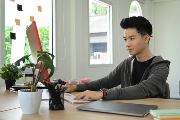 istock Thoughtful young start up businessman watching online webinar, reading business email on laptop computer. 1441334325