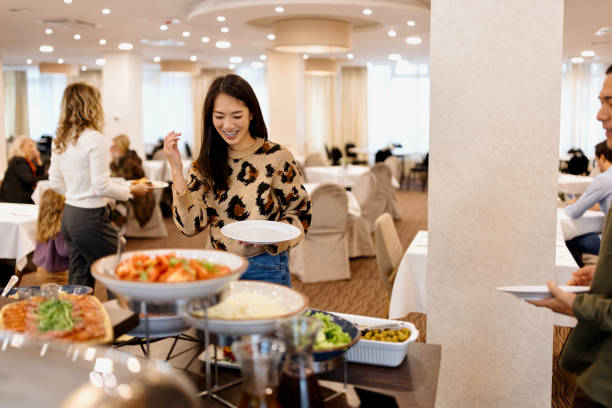 istock Woman choosing breakfast from buffet table at the hotel restaurant 1441334333