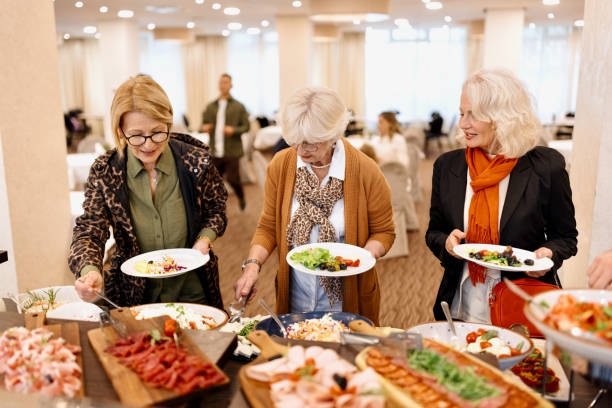 senior friends enjoying breakfast buffet at the hotel or restaurant - retirement senior adult breakfast active seniors imagens e fotografias de stock