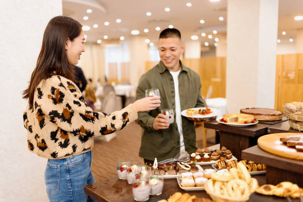 istock Couple choosing breakfast from buffet table at the hotel restaurant 1441334637