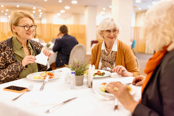 istock Senior female friends having breakfast at a hotel 1441334679