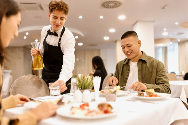 istock Waiter serving hotel guests during breakfast 1441334752