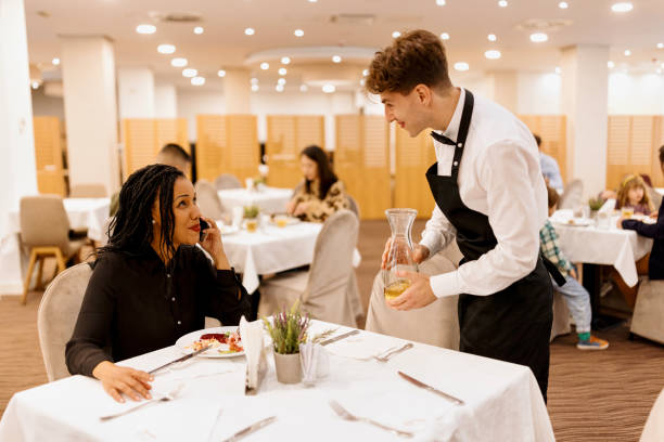 istock Waiter serving hotel guests during breakfast 1441334824