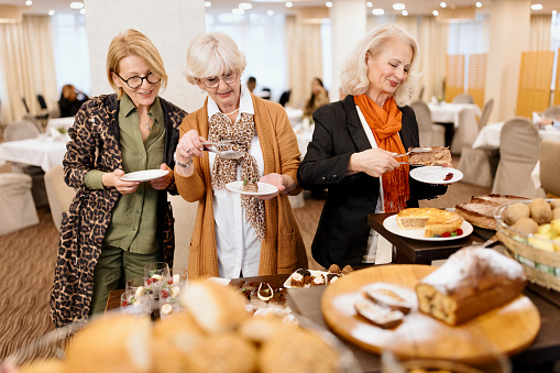 Food Buffet Catering Dining Eating Party Sharing Concept. Multi ethnic people group catering buffet food breakfast indoor in luxury hotel restaurant with meat colourful fruits and vegetables