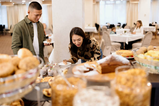 istock Couple choosing sweets from buffet table at the hotel restaurant 1441335249
