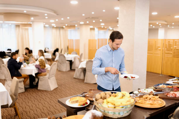 istock Business man choosing breakfast at restaurant buffet 1441335308