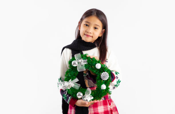 A 9-year-old girl enjoying the magic of Christmas in the living room.