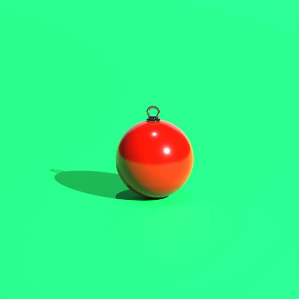 Red Christmas tree toy on a green background. 3d render