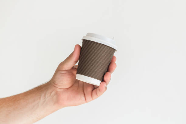 istock Hand holding takeaway paper coffee cup 1441340451