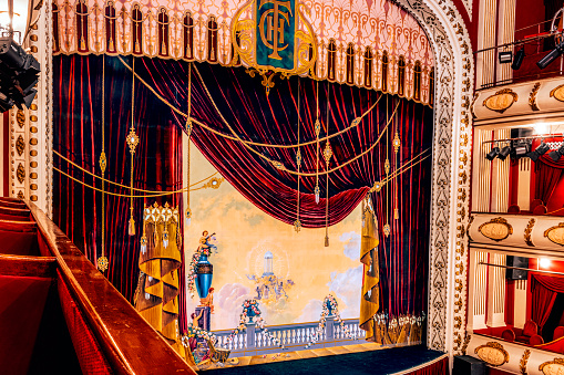 Stage curtain of a theater. View from a private box elevated from the stage.