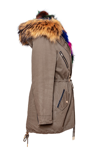 Ladies luxurious and stylish elegant designer parka with colorful lined fur on mannequin isolated on a white background. Women's Water and Windproof coat with hood.  Side view.